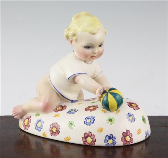 A Lenci pottery figure of a baby playing with a ball, 1930s, 17.5cm